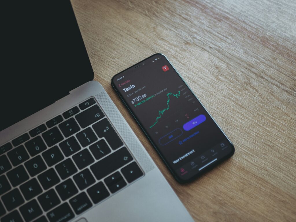 black android smartphone on macbook pro, best stock market apps