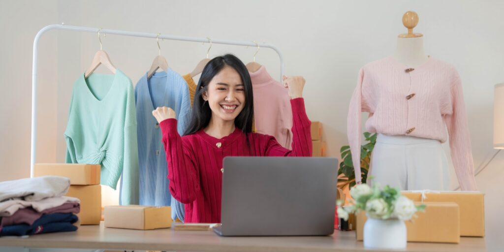 a woman sitting at a desk in front of a laptop computer, Setting Up Your Online Store