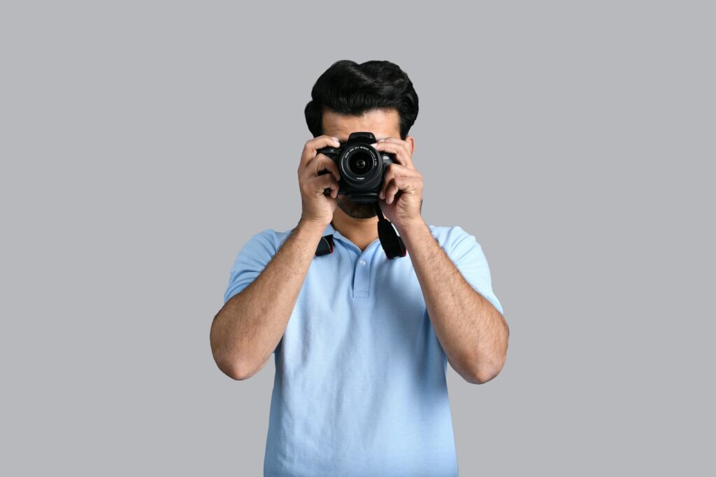 a man holding a camera, Sell stock Photos
